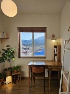 A desk facing a scenic view symbolizes clarity, reflection, and a peaceful space for growth and self-discovery.