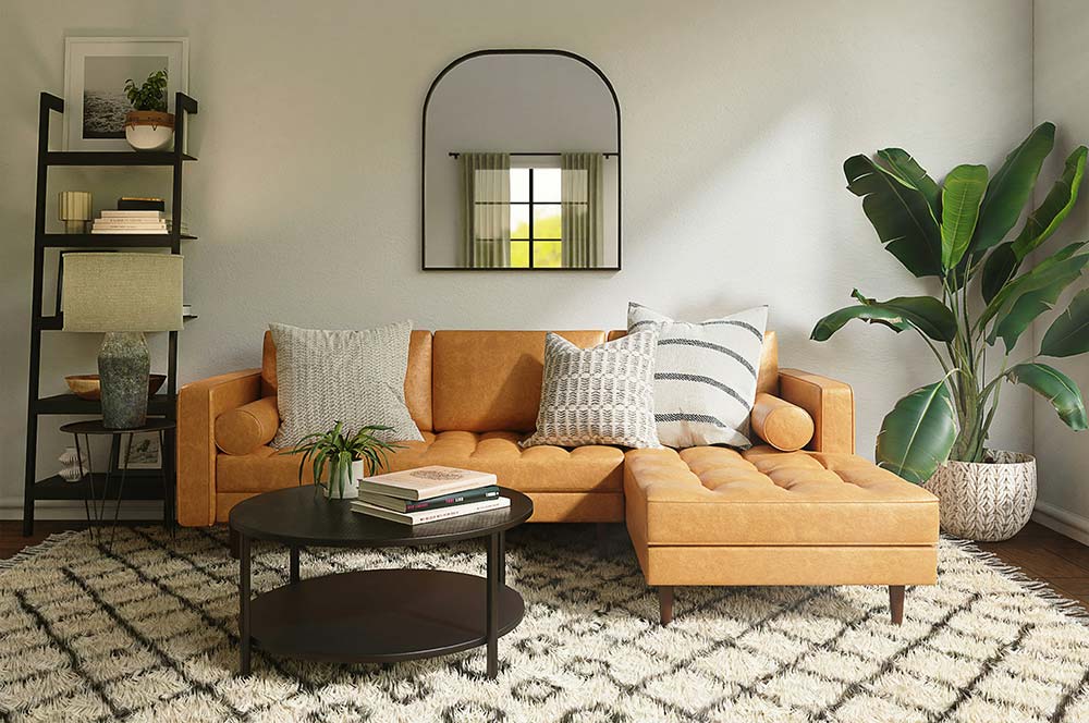 An inviting, modern living room is centered around a warm tan leather sectional sofa adorned with neutral-toned throw pillows.