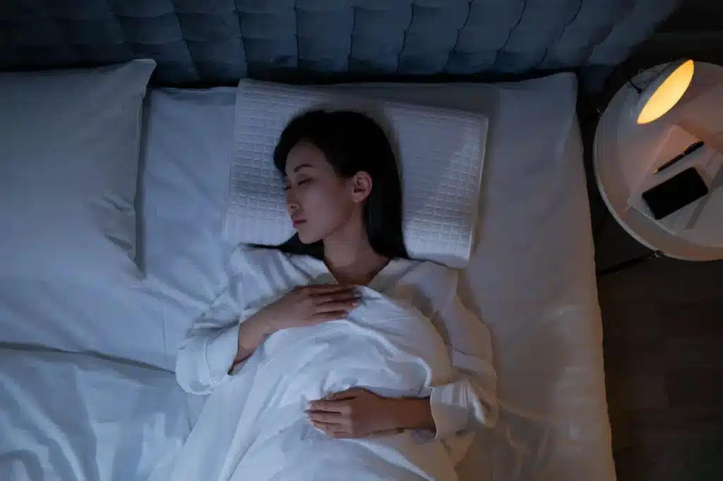 woman in bed trying to sleep