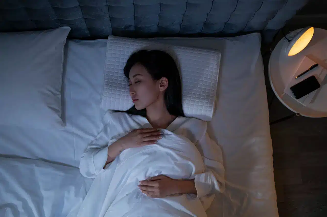 woman in bed trying to sleep