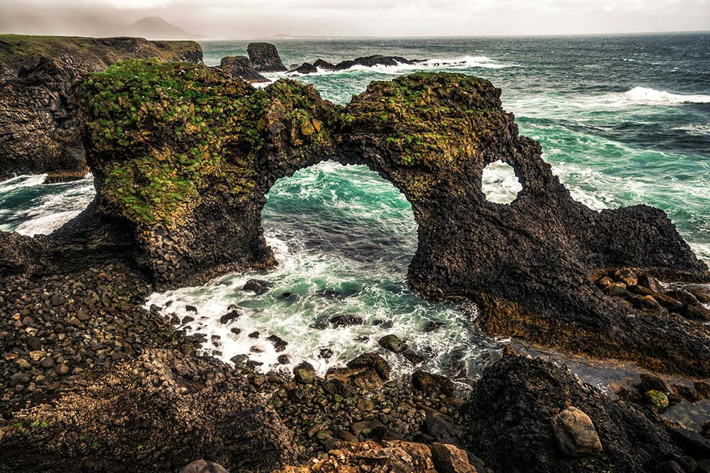 Amazing stone arch Gatklettur basalt rock on Atlantic coast