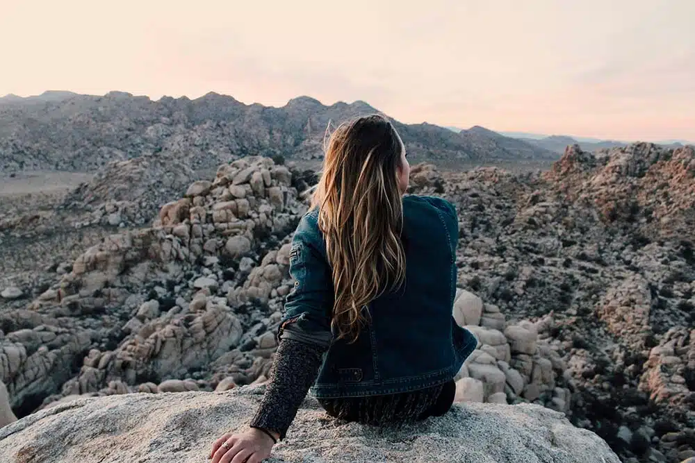 Woman sitting on rock