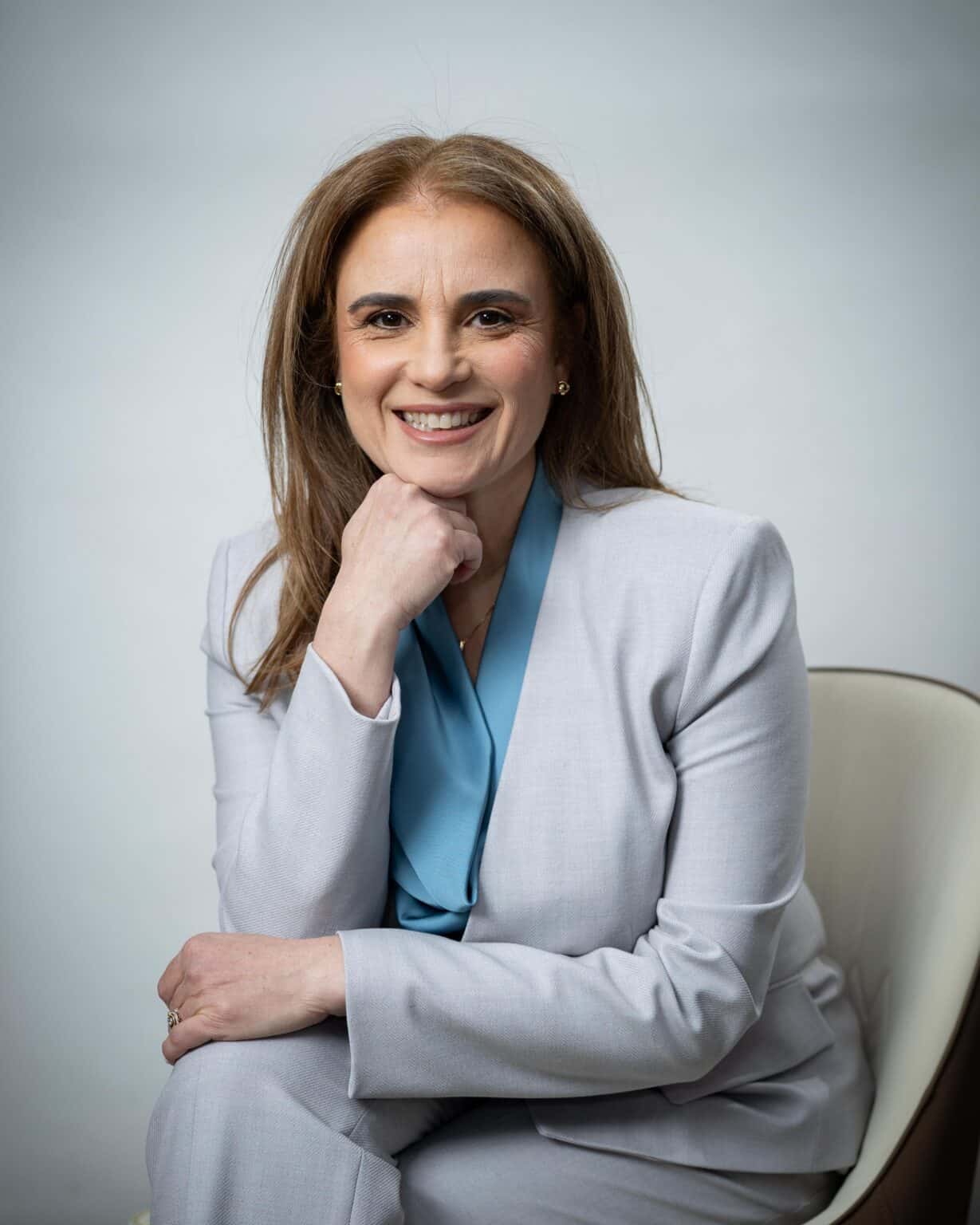 Dr. Nellie Harari, warm and approachable, smiling in professional attire, conveying trust, care, and expertise.