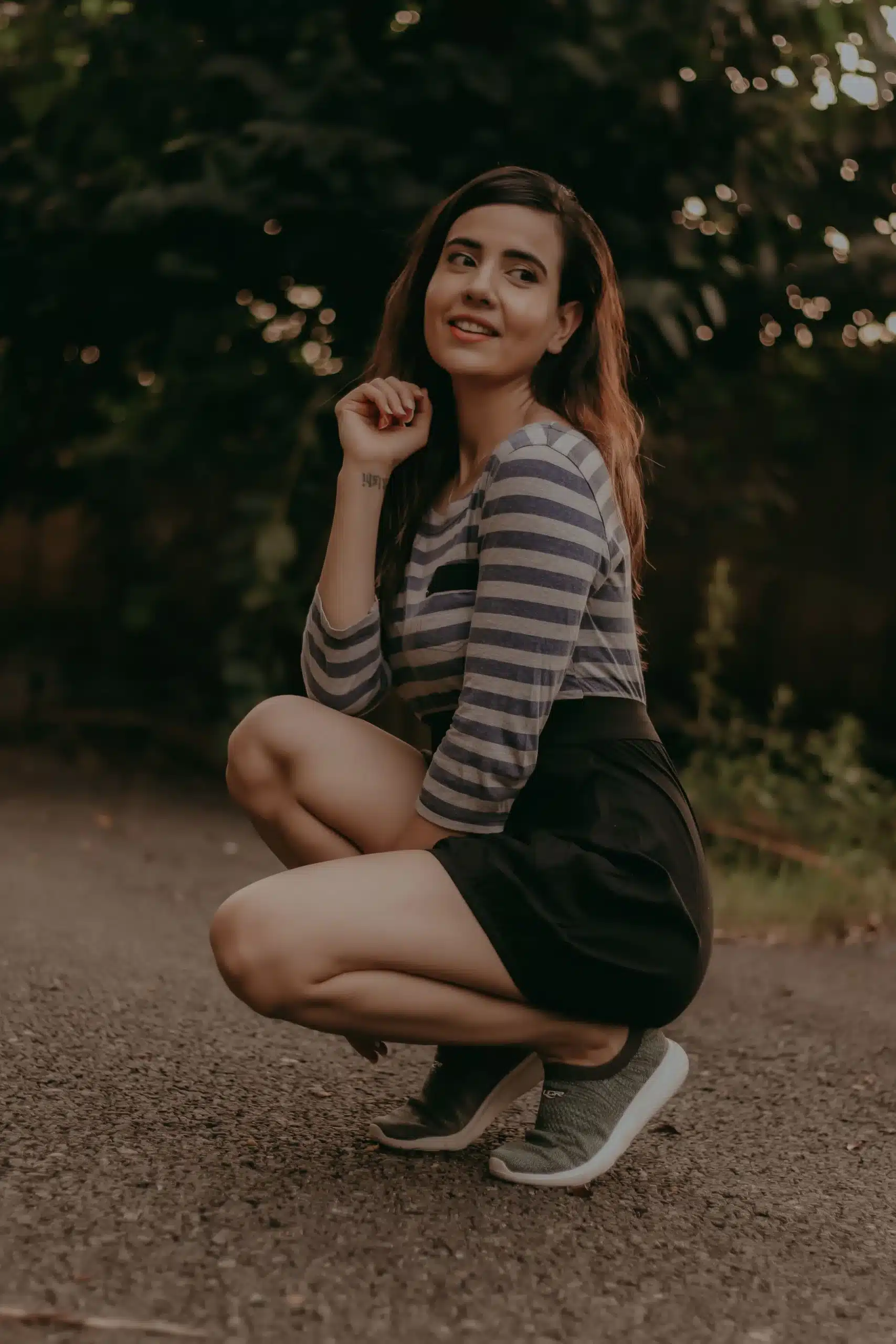A person seated on a wooden stool