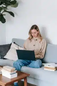 Minimalist therapy office with a sofa, a book, a coffee cup, and a tray, creating a warm, welcoming environment for reflection
