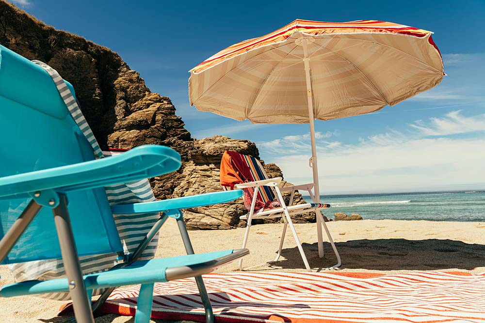 empty beach chairs and umbrella on a sunny beach