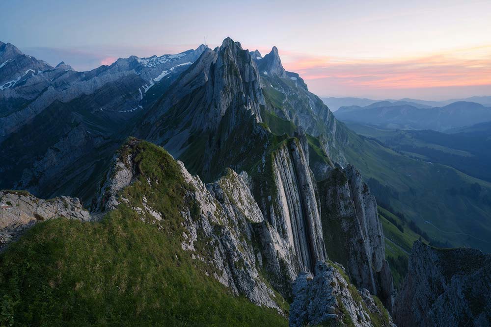 rugged mountain peaks and grassy ridges at dawn