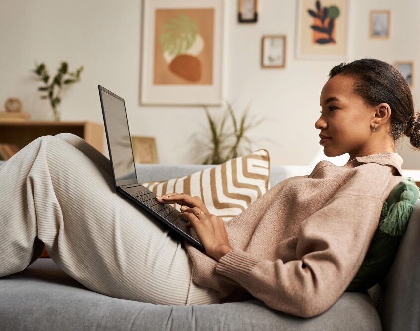 A woman smiling warmly, expressing confidence, ease, and a sense of emotional well-being and self-acceptance.